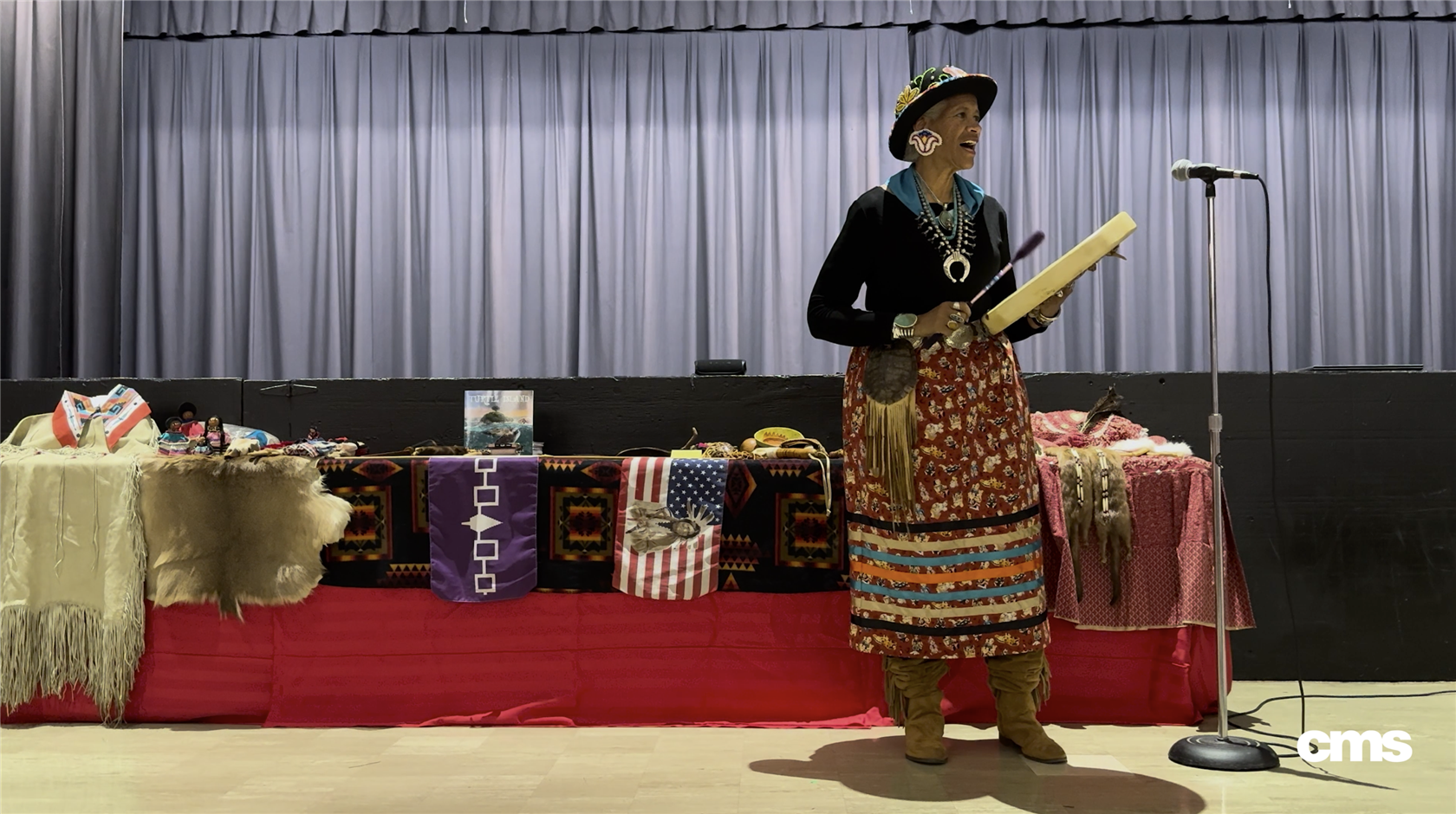   Native American woman singing and playing music